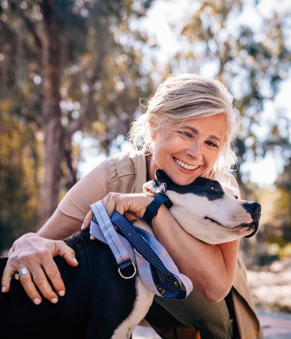 woman smiling with her dog